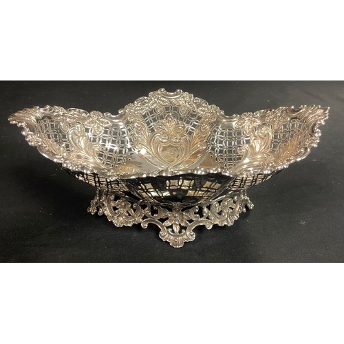 177 - A Victorian silver shaped oval cake basket, pierced and chased with flowers and scrolls, 24.5cm wide... 