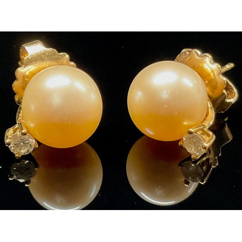 434 - A pair of cultured pearl and white stone earrings, yellow metal mounts, stamped 417, 5.4g gross