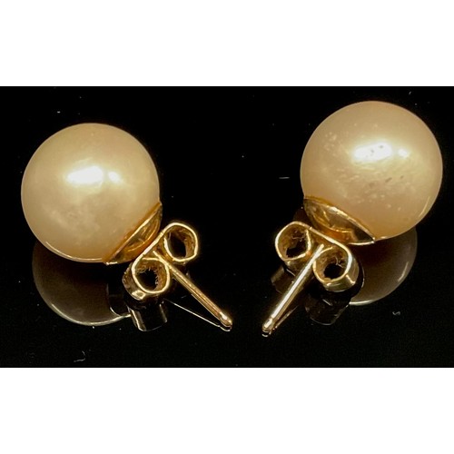 439 - A pair of cultured pearl earrings, unmarked yellow metal mounts, 3.5g gross