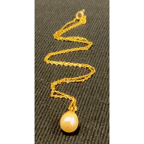 444 - A gold coloured metal and pearl drop pendant, gold coloured metal chain