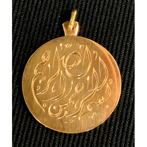 454 - A gold coloured metal pendant