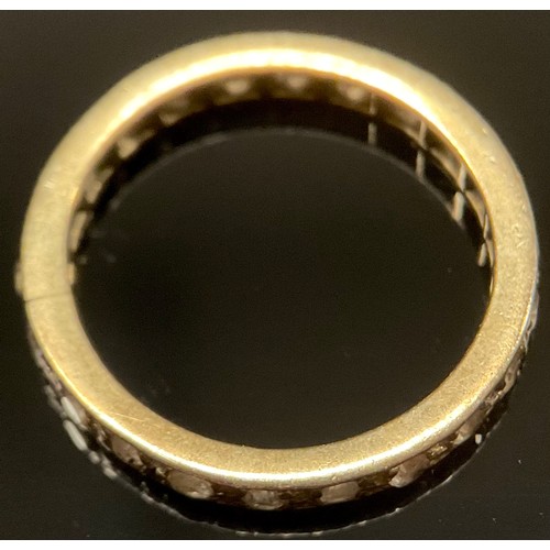 455 - An unmarked white stone (not diamonds) and mixed metal eternity ring, unmarked, 2g gross