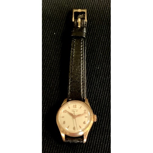 474 - A lady's Longines gold coloured metal wristwatch, black leather strap