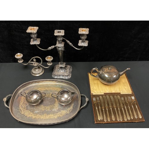 219 - A silver plated oval gallery tray; a Walker and Hall three piece tea set; a small three branch cande... 