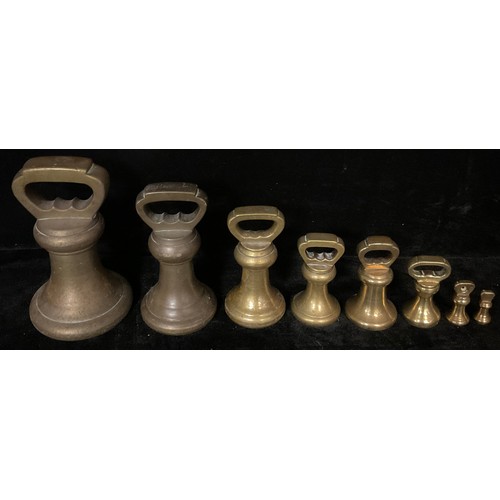 222 - A collection of eight Victorian graduated brass bell weights, the largest 14lbs