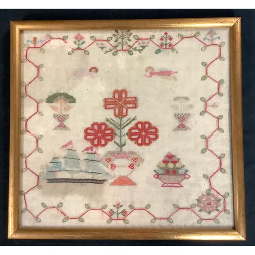 228 - Textiles - an early 19th century rectangular marine sampler, worked with a three masted ship, cherub... 