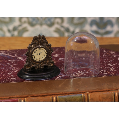 6068 - A late 19th century/early 20th century dolls house miniature tinplate mantel timepiece, the circular... 