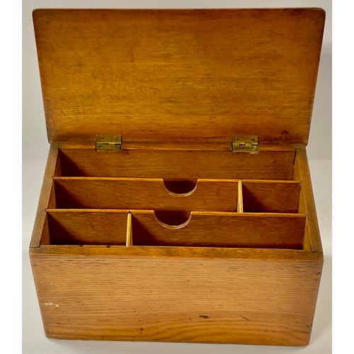 351 - A late Victorian oak slope top stationery box, hinged cover applied with a brass plaque depicting a ... 