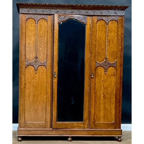 408 - An oak two-piece bedroom suite, comprising wardrobe and dressing chest, each frieze carved with shel... 