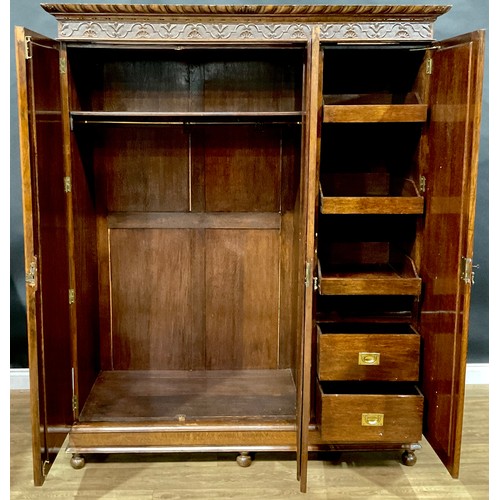 408 - An oak two-piece bedroom suite, comprising wardrobe and dressing chest, each frieze carved with shel... 