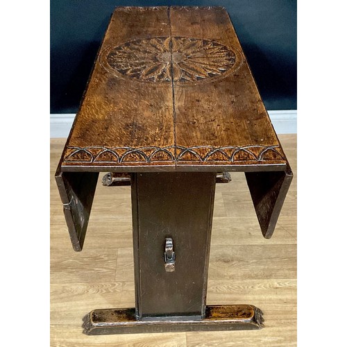 410 - A 17th century style oak trestle table, rectangular top carved with a flower head, a figure, thistle... 