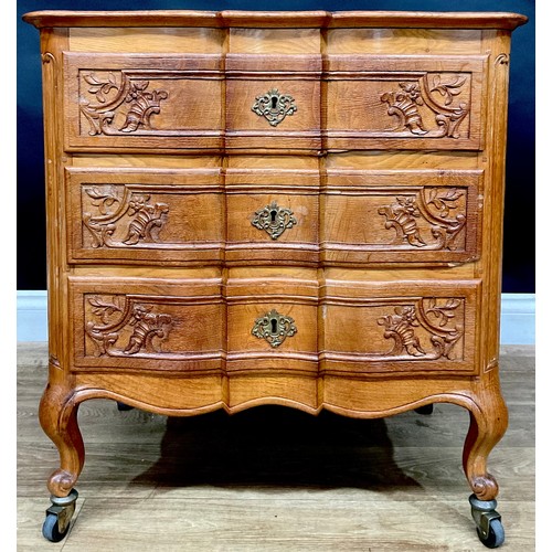 418 - An 18th century style Dutch design arc-en-arbalète chest, of three long drawers and small proportion... 