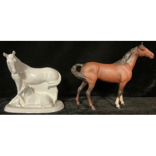 450 - A Royal Doulton brown matt glazed model horse, boxed; a Royal Doulton gloss white mother and foal ho... 