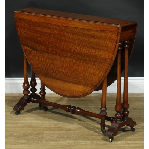 2208 - A Victorian ripple walnut Sutherland table, oval top with fall leaves, turned supports and stretcher... 