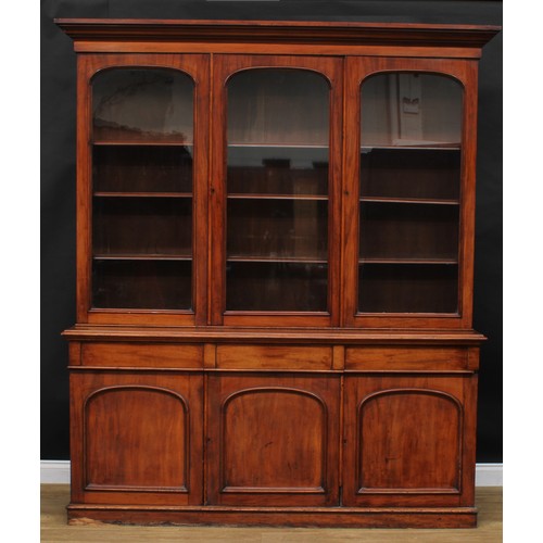 2211 - A Victorian mahogany library bookcase, moulded cornice above three glazed doors enclosing adjustable... 