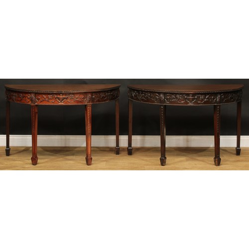 2424 - An Adam Revival mahogany dining table, discorectangular top above a deep frieze applied with urns an... 