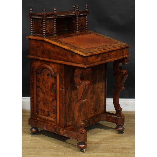 1581 - A 19th century burr yew Davenport desk, possibly Irish, shaped superstructure with a pair of small d... 