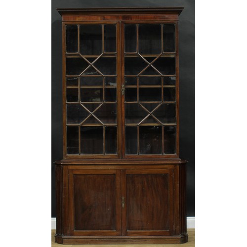 1632 - A 19th century mahogany library bookcase, outswept cornice with meandrous border above a pair of ast... 