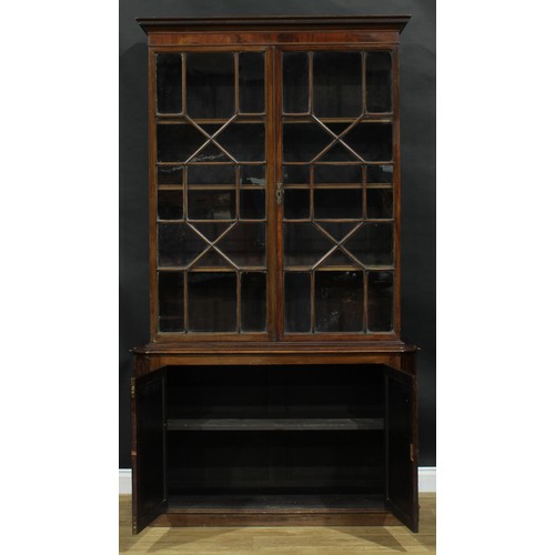 1632 - A 19th century mahogany library bookcase, outswept cornice with meandrous border above a pair of ast... 