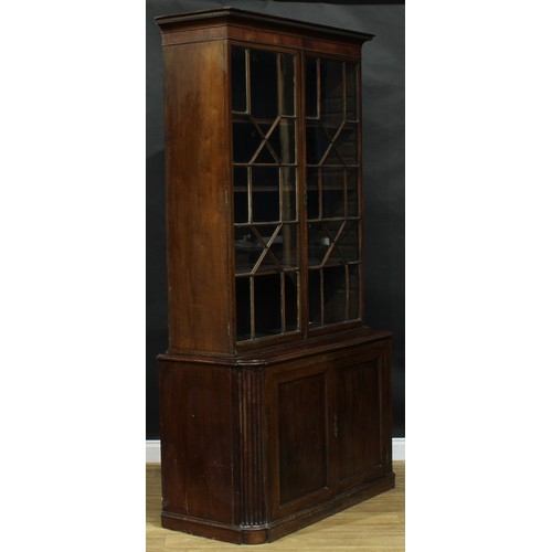 1632 - A 19th century mahogany library bookcase, outswept cornice with meandrous border above a pair of ast... 