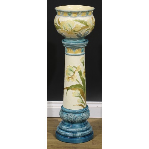 92 - A late 19th century Burmantofts Faience jardinière on stand, tube lined in low relief with Flag Iris... 