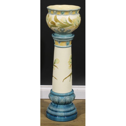 92 - A late 19th century Burmantofts Faience jardinière on stand, tube lined in low relief with Flag Iris... 