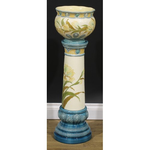 92 - A late 19th century Burmantofts Faience jardinière on stand, tube lined in low relief with Flag Iris... 