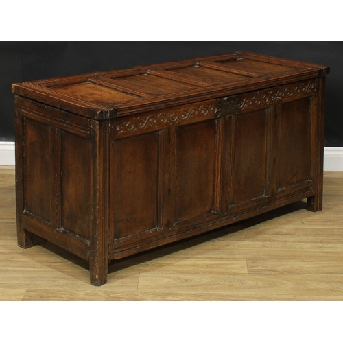 2156 - A late 17th century oak blanket chest, hinged top above a frieze carved with scrolling stylised leav... 