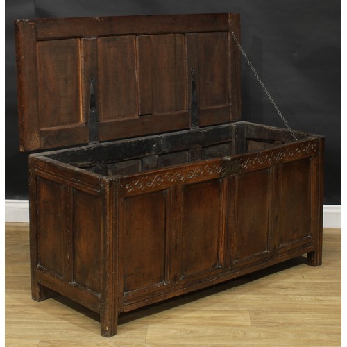 2156 - A late 17th century oak blanket chest, hinged top above a frieze carved with scrolling stylised leav... 