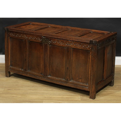 2156 - A late 17th century oak blanket chest, hinged top above a frieze carved with scrolling stylised leav... 