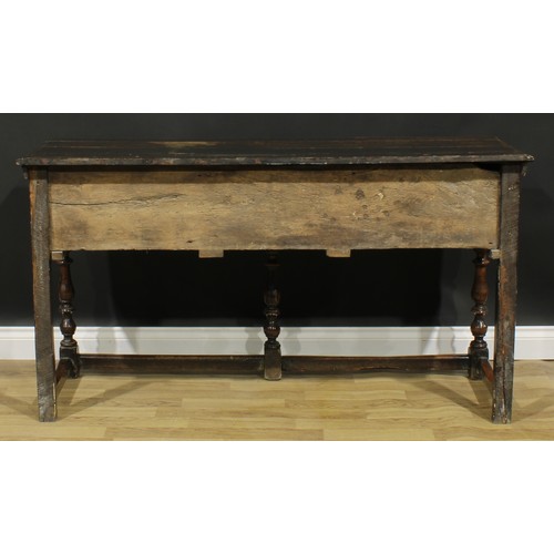 1989 - An 18th century design oak dresser, moulded cornice above three plate rack shelves, the projecting b... 