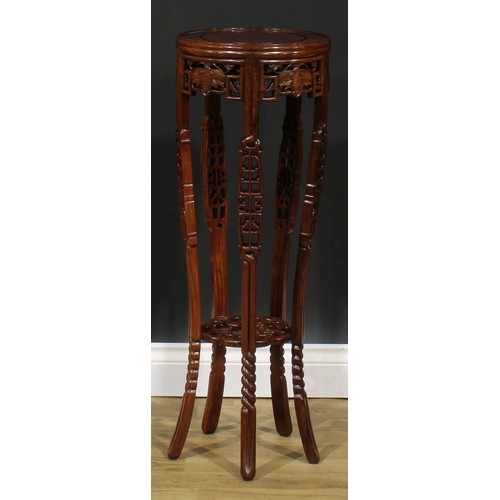 2212 - A Chinese hardwood jardiniere stand, circular top, shaped apron pierced and carved with moths, outsw... 