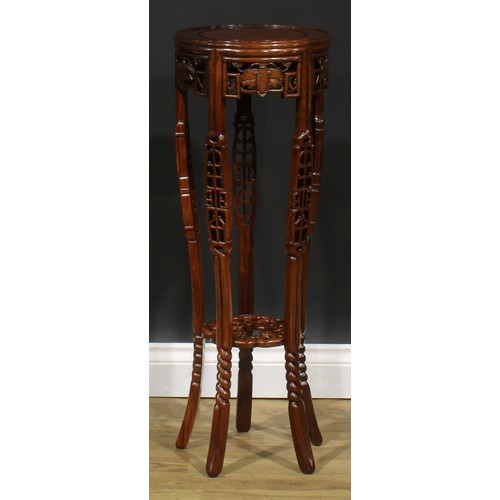 2212 - A Chinese hardwood jardiniere stand, circular top, shaped apron pierced and carved with moths, outsw... 