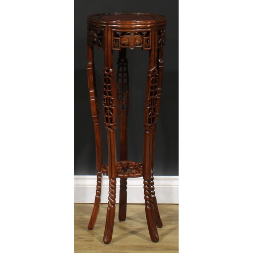 2212 - A Chinese hardwood jardiniere stand, circular top, shaped apron pierced and carved with moths, outsw... 