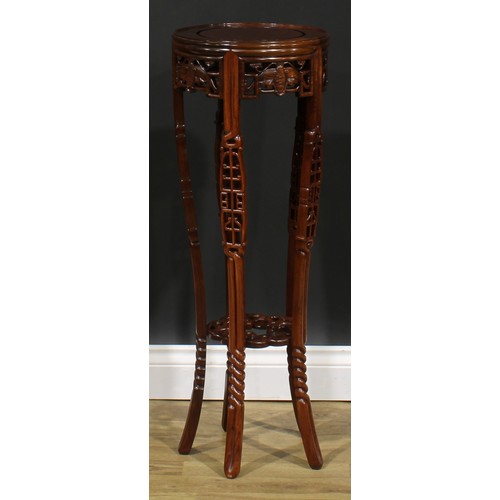 2212 - A Chinese hardwood jardiniere stand, circular top, shaped apron pierced and carved with moths, outsw... 