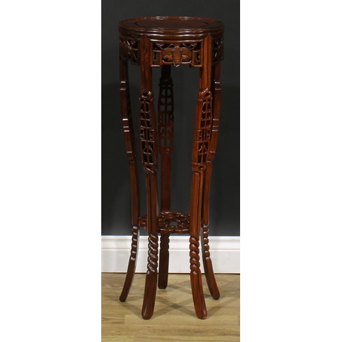 2212 - A Chinese hardwood jardiniere stand, circular top, shaped apron pierced and carved with moths, outsw... 