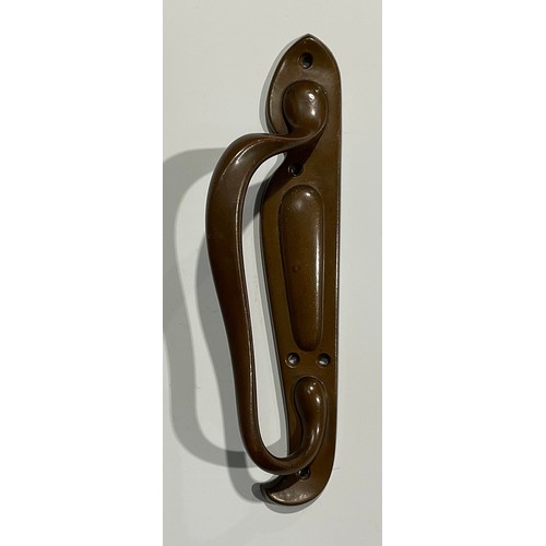 1824 - A pair of Art Nouveau bronze door pulls, the handles in typical sinuous form, on asymmetrical backpl... 