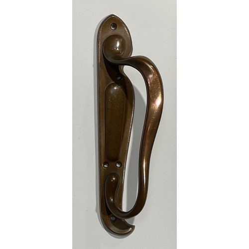 1824 - A pair of Art Nouveau bronze door pulls, the handles in typical sinuous form, on asymmetrical backpl... 