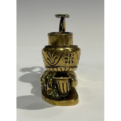 1804 - A late 19th century brass candlestick, in the Grand Tour manner, as a sandaled foot, with vesta hold... 