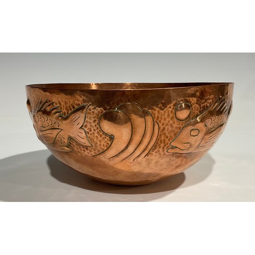 2345 - A Newlyn Arts & Crafts copper bowl, repousse embossed with a repetitive band of stylised fish, on a ... 