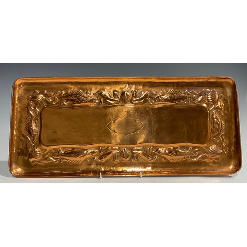 2347 - A Newlyn Arts & Crafts rounded rectangular copper tray, repousse embossed with a repetitive band of ... 