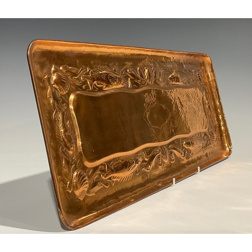 2347 - A Newlyn Arts & Crafts rounded rectangular copper tray, repousse embossed with a repetitive band of ... 