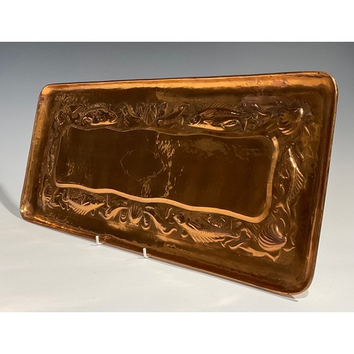 2347 - A Newlyn Arts & Crafts rounded rectangular copper tray, repousse embossed with a repetitive band of ... 