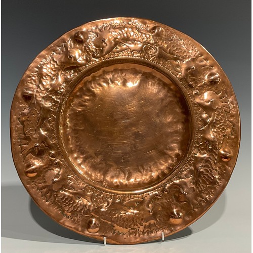 2344 - A Newlyn Arts & Crafts circular copper tray, the broad border repousse embossed with a repetitive ba... 