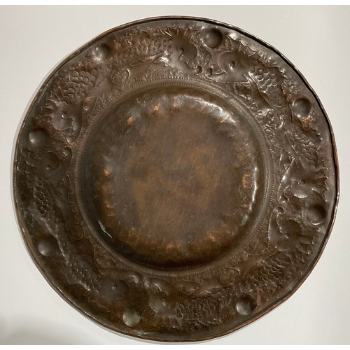 2344 - A Newlyn Arts & Crafts circular copper tray, the broad border repousse embossed with a repetitive ba... 