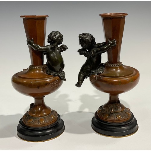 1770 - Auguste Moreau, after, a pair of bronze pedestal vases, each cast and applied with putti, the main b... 