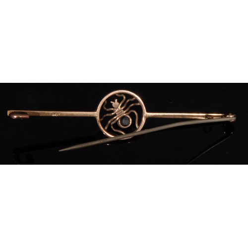 1504 - An early 20th century 9ct rose gold bar brooch, the central circular aperture with a spider, the abd... 