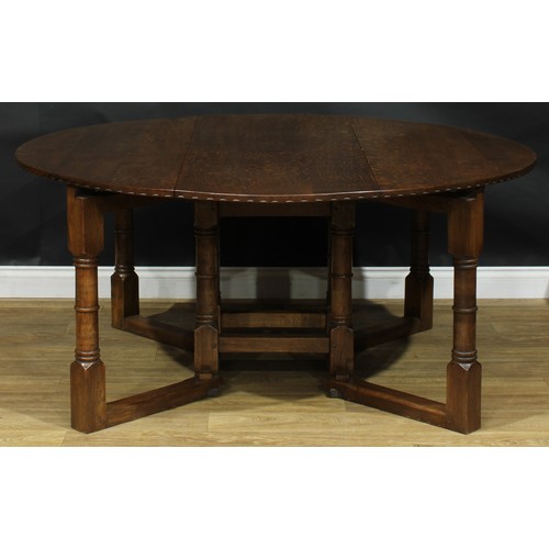 2216 - An oak double-gateleg dining table and eight dining chairs, probably Rupert or Nigel Griffiths Monas... 