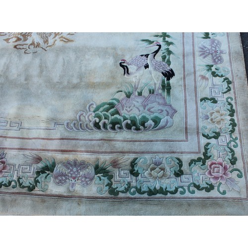 1771 - A Chinese wool carpet, worked in the Peking manner with Chinese pond herons, bamboo, flowers and lea... 