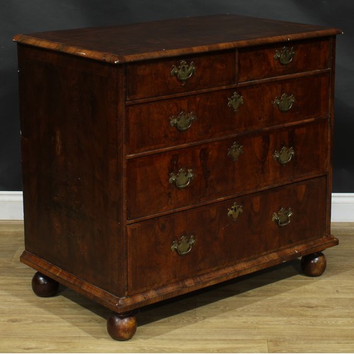 2351 - A Queen Anne walnut chest, featherbanded top above two short and three long graduated drawers, skirt... 